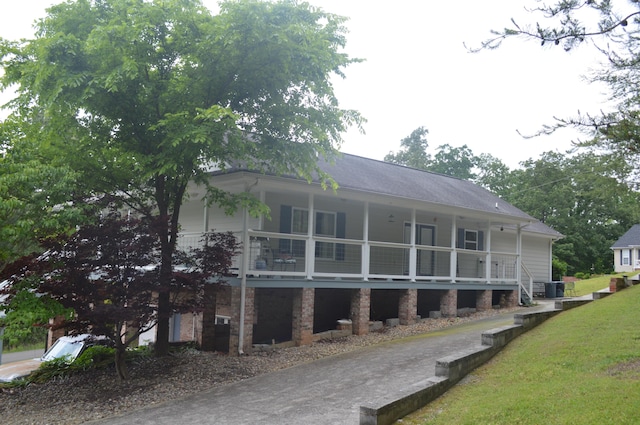 back of property featuring a porch and a lawn