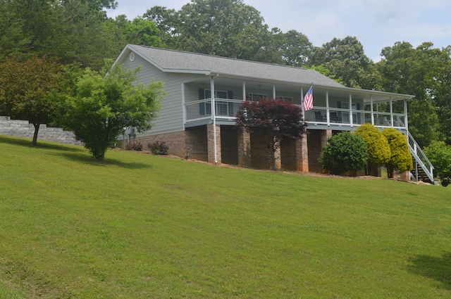 exterior space featuring a balcony and a lawn