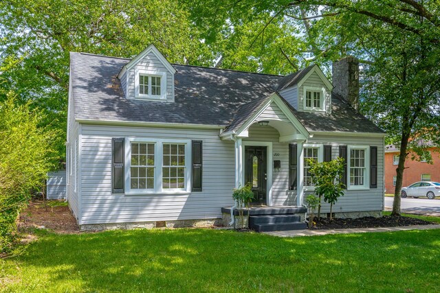 new england style home with a front yard