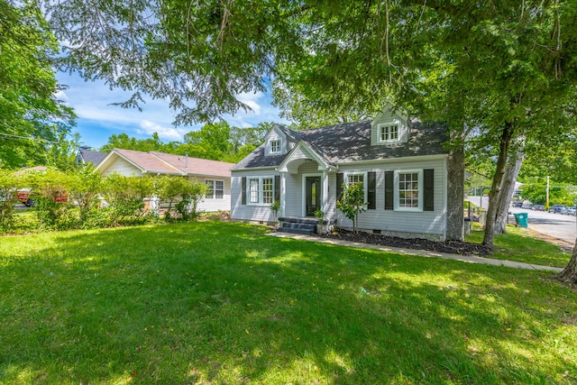 cape cod home featuring a front yard