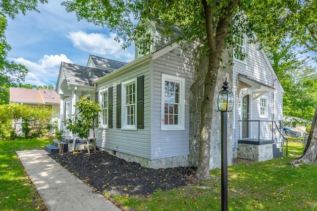 view of property exterior featuring a lawn