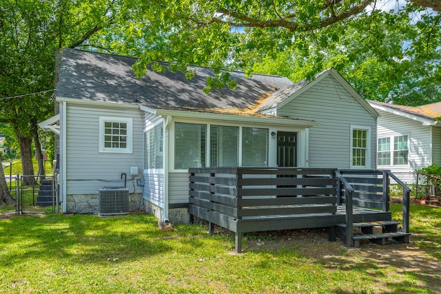 back of property featuring a yard, a deck, and central AC