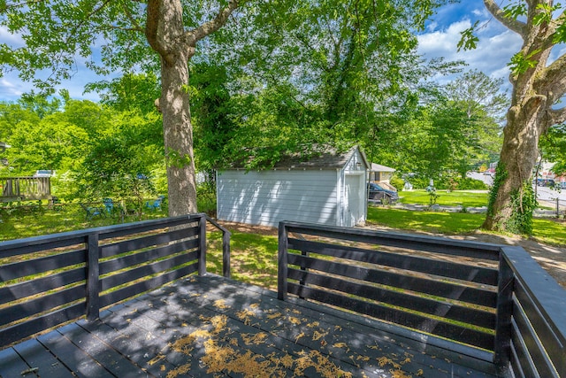 deck featuring a yard and a storage unit