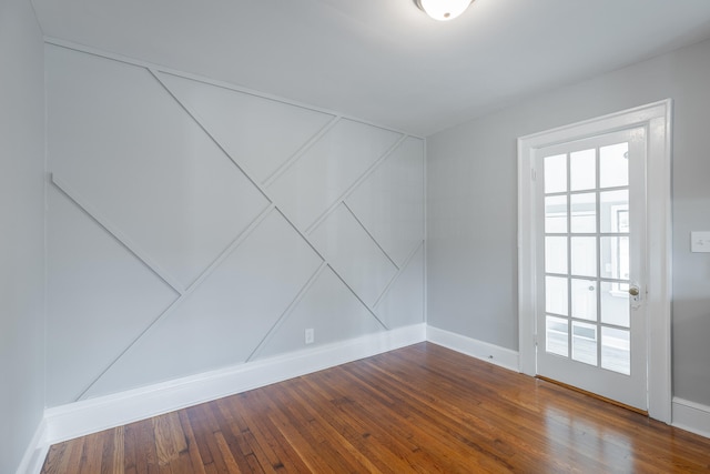 empty room featuring wood-type flooring and a wealth of natural light