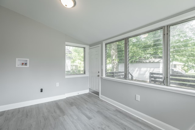 unfurnished room with vaulted ceiling and hardwood / wood-style floors