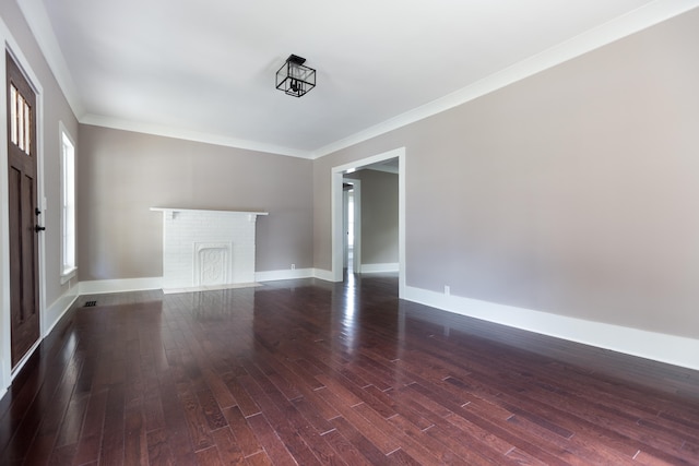 unfurnished room with ornamental molding, dark hardwood / wood-style flooring, and a fireplace