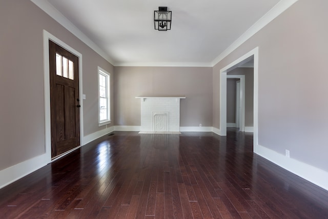 entryway featuring ornamental molding, dark wood-type flooring, and a brick fireplace