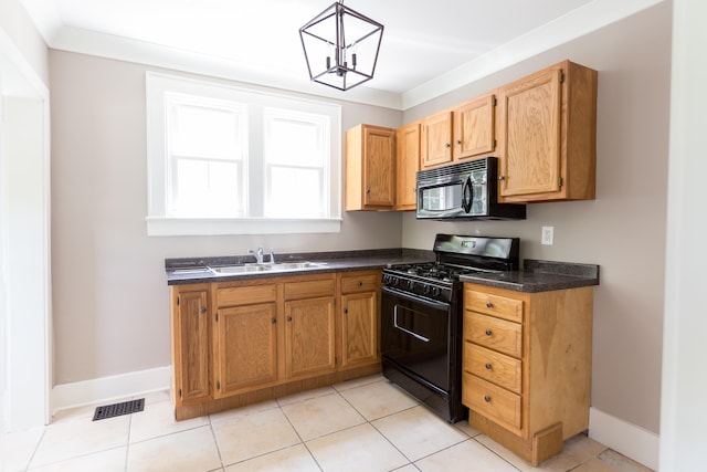 kitchen featuring a notable chandelier, light tile patterned floors, black appliances, sink, and hanging light fixtures