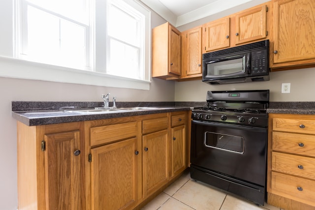 kitchen with black appliances, sink, and light tile patterned floors