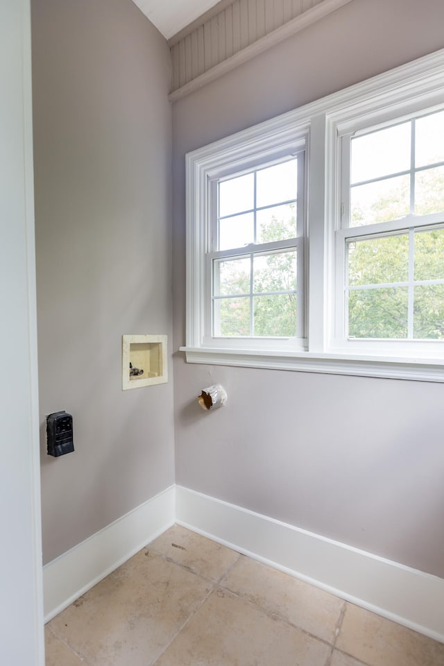 washroom featuring hookup for a washing machine and light tile patterned flooring