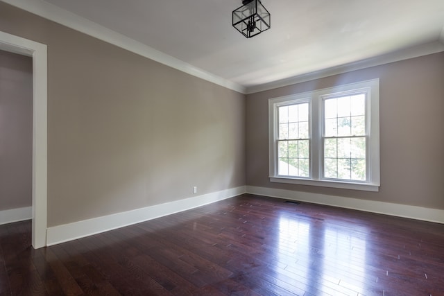 unfurnished room featuring ornamental molding and dark hardwood / wood-style flooring