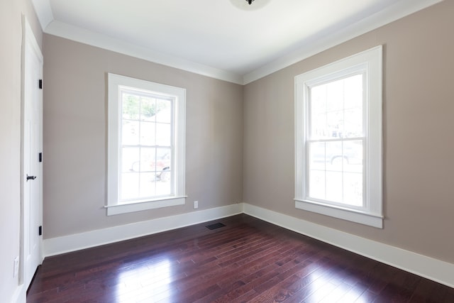 unfurnished room featuring crown molding and dark wood-type flooring