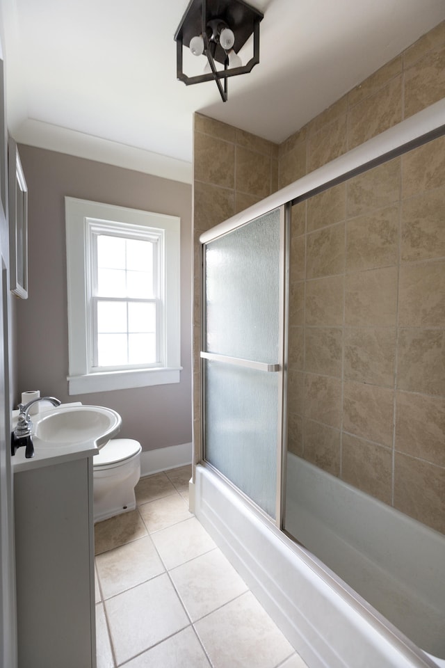 full bathroom featuring tile patterned floors, toilet, combined bath / shower with glass door, and vanity