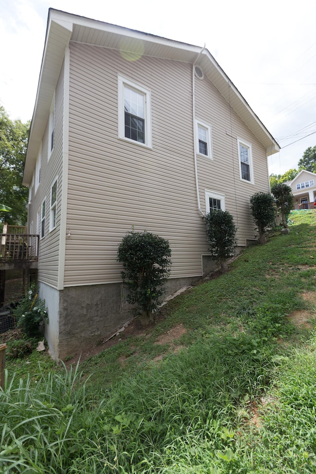 view of side of home featuring a lawn