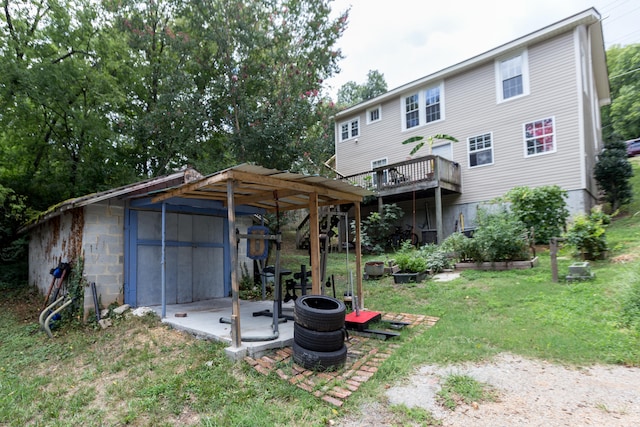 back of property with a patio area and a lawn