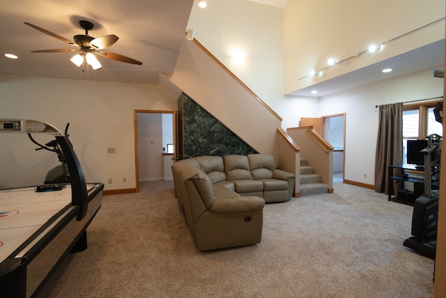 carpeted living room with ceiling fan