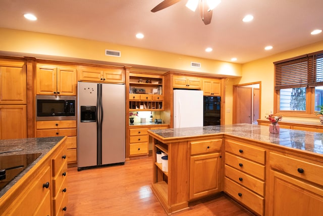 kitchen with ceiling fan, light wood-type flooring, and appliances with stainless steel finishes