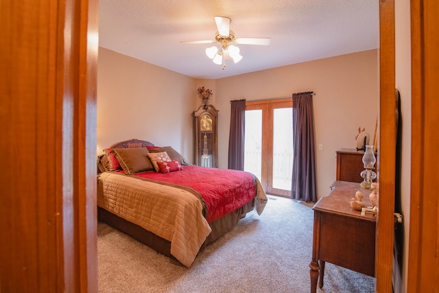 bedroom featuring a textured ceiling, access to outside, light carpet, and ceiling fan