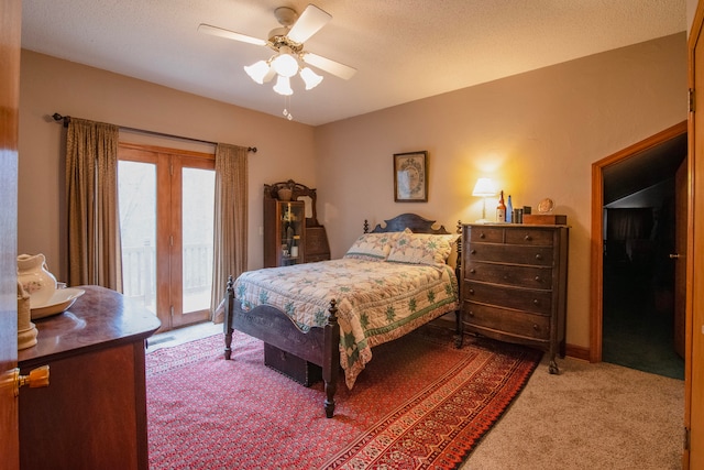 carpeted bedroom with ceiling fan, access to exterior, and a textured ceiling