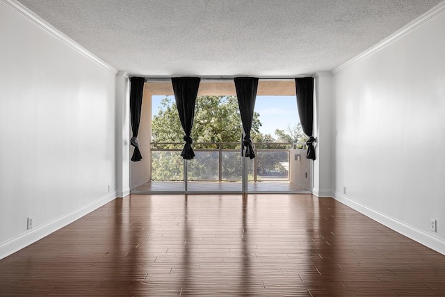 spare room featuring floor to ceiling windows, dark hardwood / wood-style floors, a textured ceiling, and ornamental molding