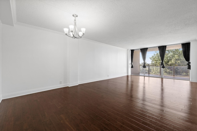 unfurnished room with crown molding, dark wood-type flooring, expansive windows, and a textured ceiling