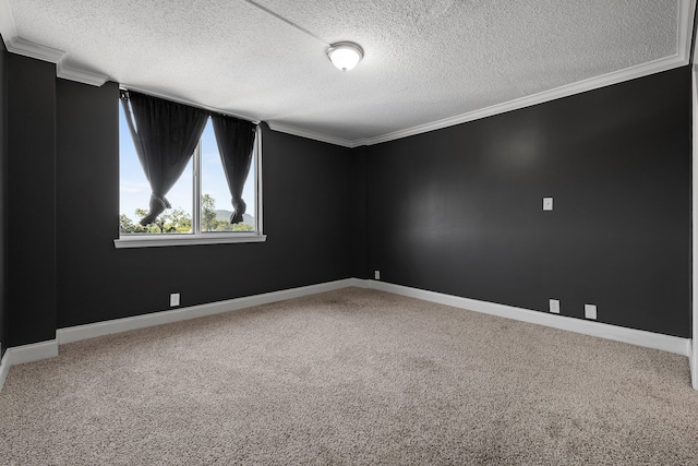 carpeted spare room featuring ornamental molding and a textured ceiling