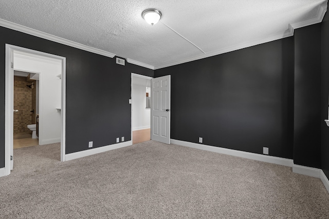 carpeted empty room featuring ornamental molding and a textured ceiling