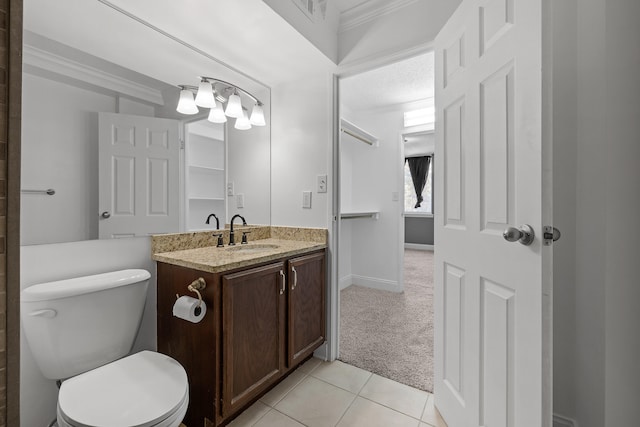 bathroom with tile patterned floors, toilet, crown molding, and vanity