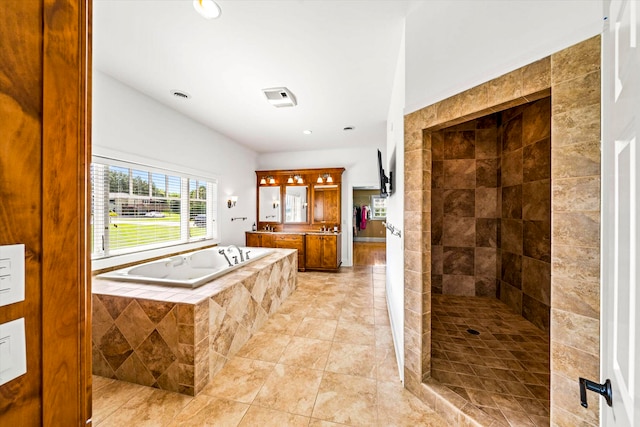 bathroom featuring tile patterned floors, shower with separate bathtub, and vanity