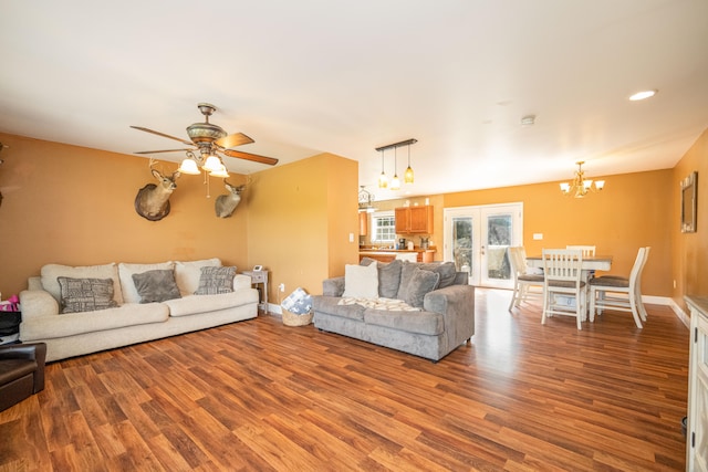 living room featuring ceiling fan with notable chandelier, french doors, and hardwood / wood-style floors