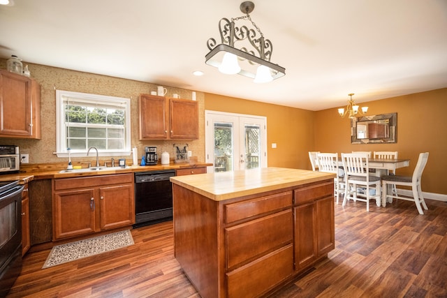 kitchen with dishwasher, a center island, dark hardwood / wood-style floors, and sink