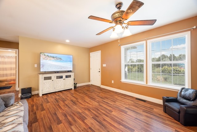 living room featuring hardwood / wood-style floors and ceiling fan