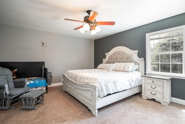 bedroom featuring light colored carpet and ceiling fan