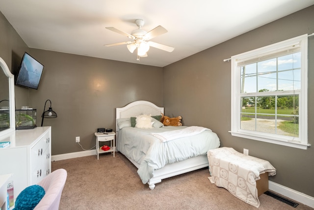 bedroom featuring light colored carpet and ceiling fan