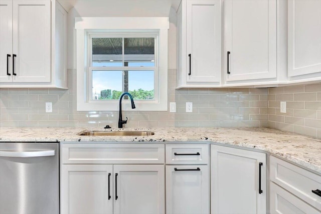 kitchen with dishwasher, sink, white cabinets, and decorative backsplash