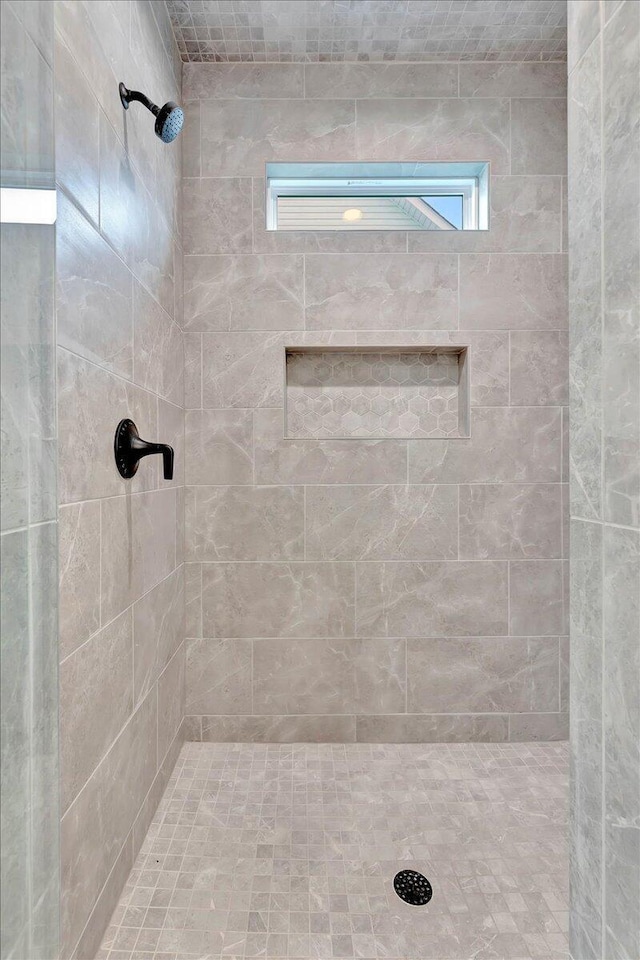 bathroom with tiled shower