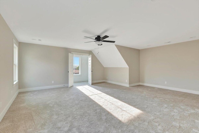 additional living space featuring a ceiling fan, baseboards, and carpet floors