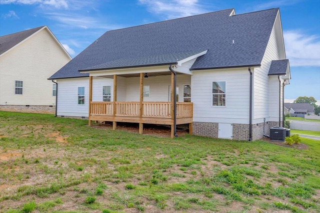 back of house with a yard and central air condition unit