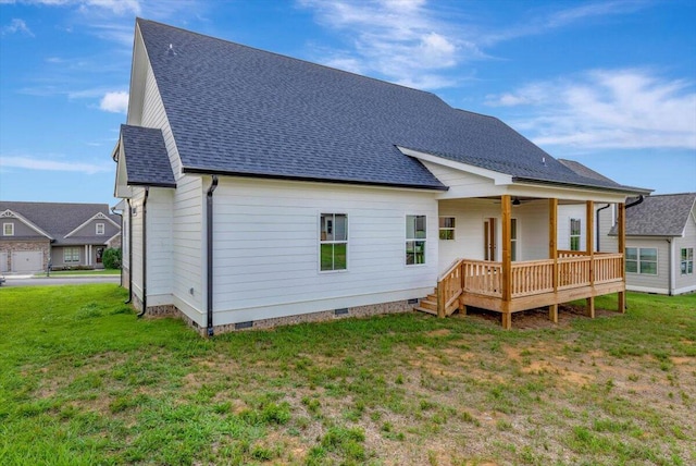 rear view of house with a lawn