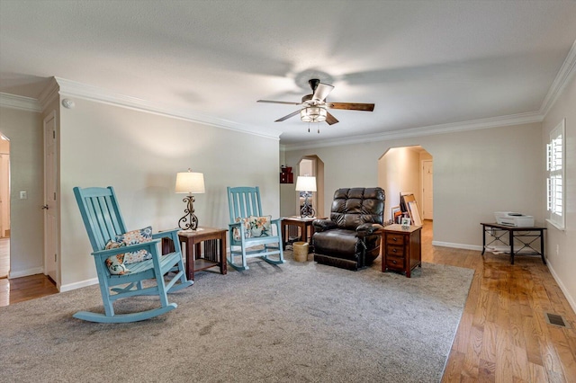 sitting room with a textured ceiling, ceiling fan, ornamental molding, and light hardwood / wood-style floors