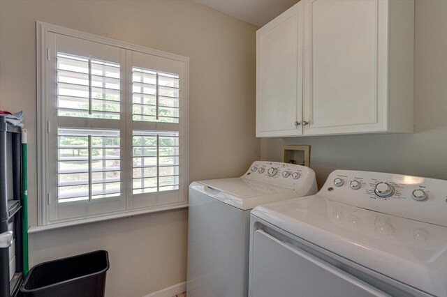 laundry room with cabinets and washer and clothes dryer