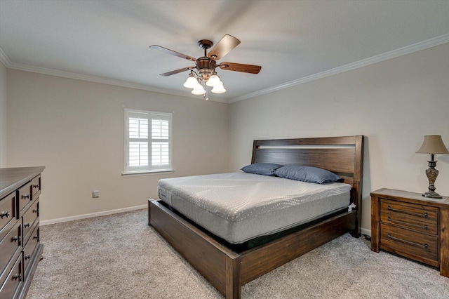 carpeted bedroom with ceiling fan and ornamental molding