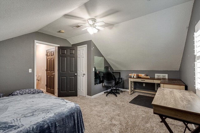 carpeted bedroom with lofted ceiling, ceiling fan, and a textured ceiling