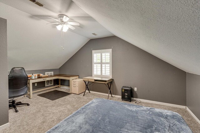 interior space featuring a textured ceiling, ceiling fan, and vaulted ceiling