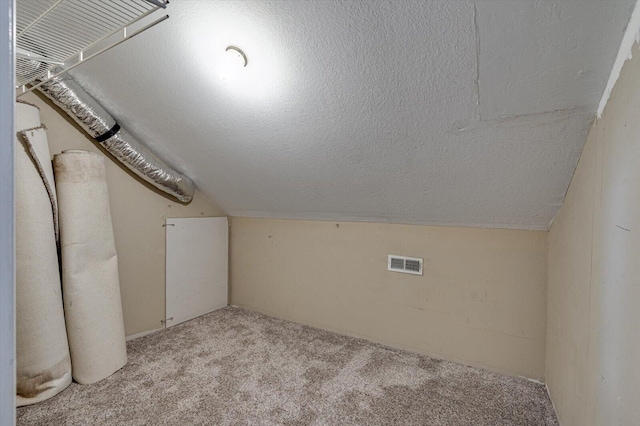 bonus room with vaulted ceiling, a textured ceiling, and carpet