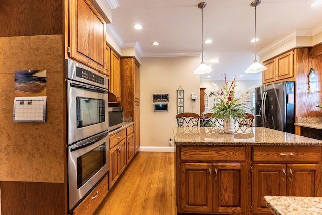 kitchen featuring light wood-style flooring, a center island, stainless steel appliances, brown cabinetry, and crown molding