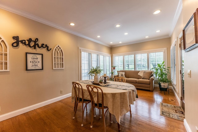 dining area with crown molding, recessed lighting, wood finished floors, and baseboards