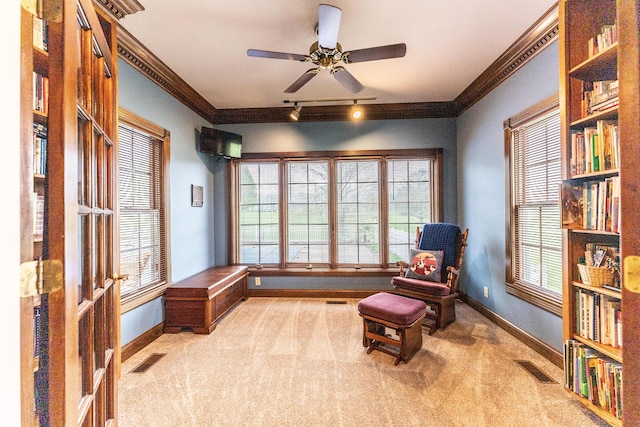 living area featuring crown molding, baseboards, visible vents, and carpet floors