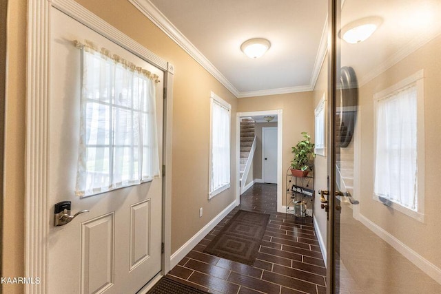 doorway to outside featuring wood finish floors, stairway, baseboards, and ornamental molding