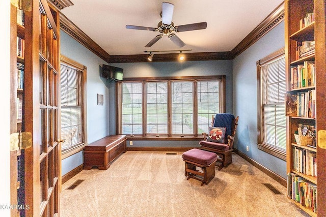 sitting room featuring visible vents, baseboards, ornamental molding, and carpet flooring